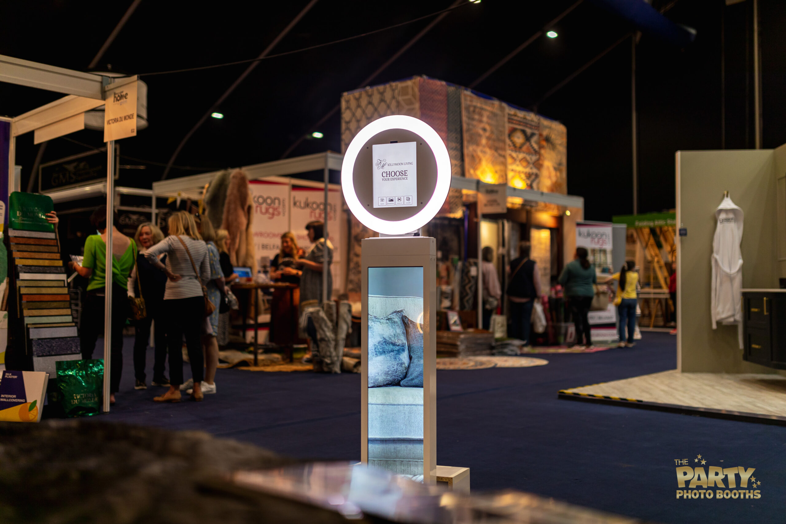 iPad booth with LED ring and TV screen playing a promo video