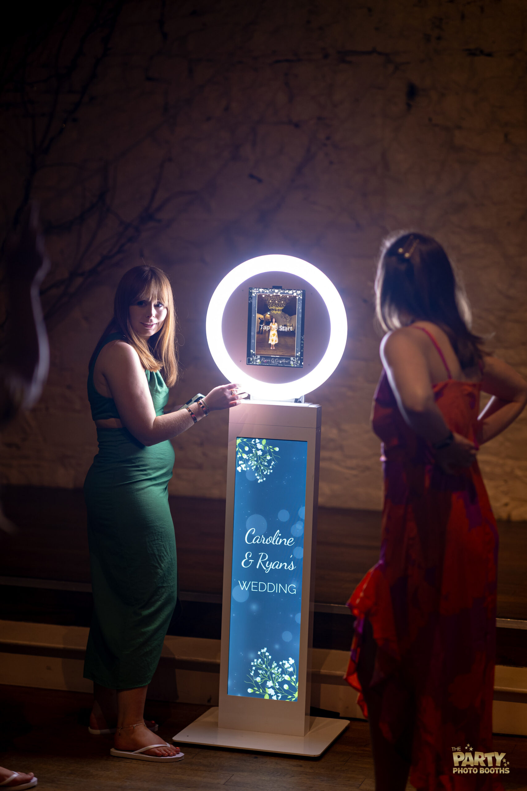 Wedding guests getting ready to use the Mobi Auura booth and have their photos taken