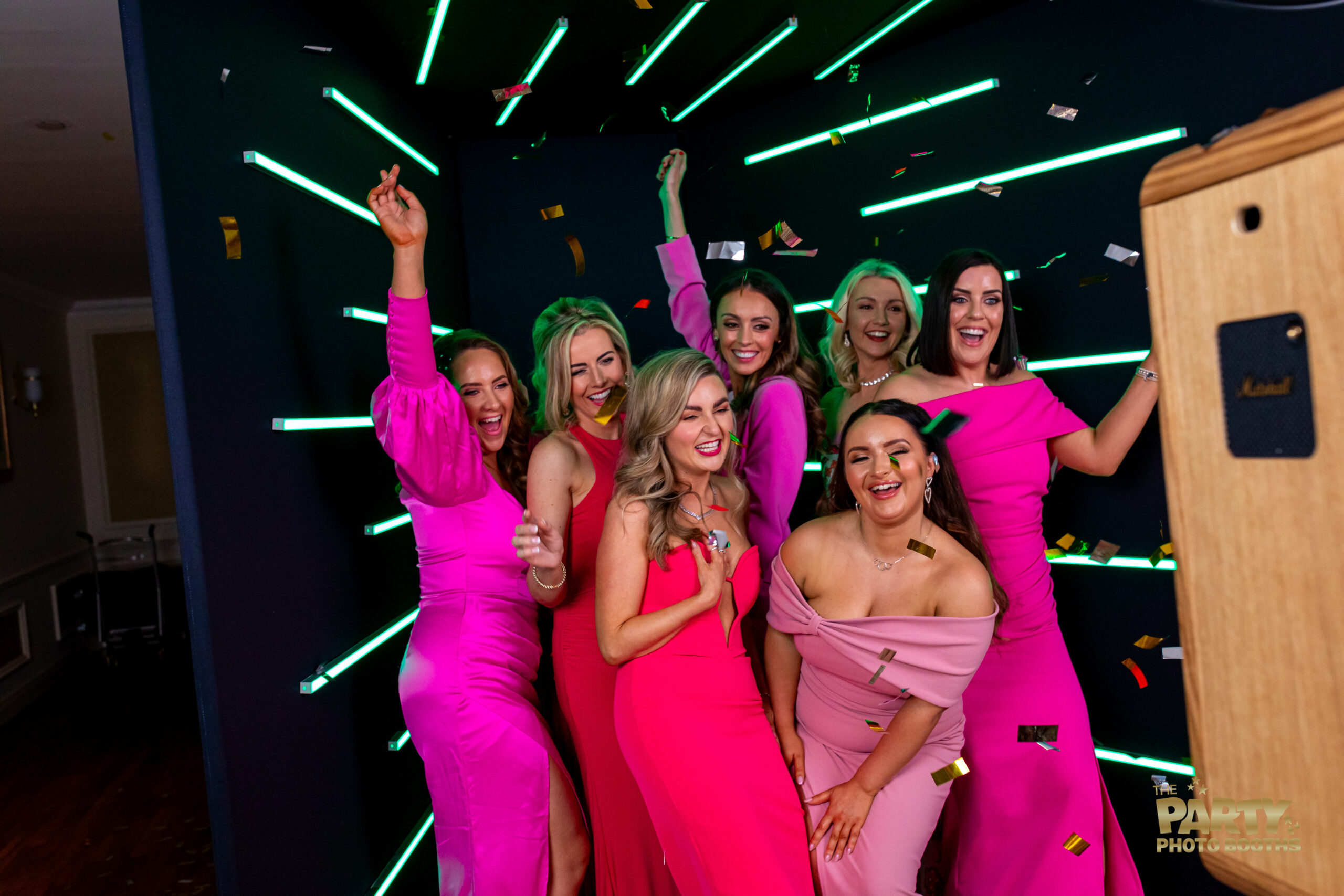 Group of women in pink dresses smiling